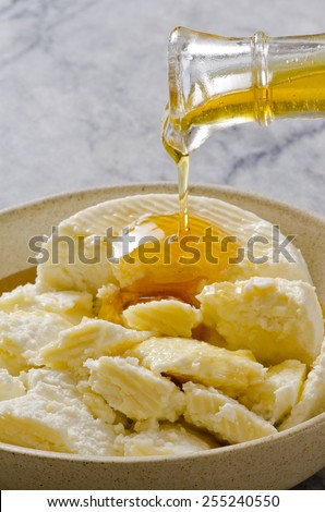 Agave Syrup pouring on Cottage Cheese. Alternative sweetener to sugar. Selective focus.
