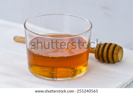 Agave syrup in a glass. Alternative sweetener to sugar. Selective focus. White background.