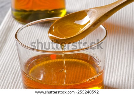 Agave Syrup pouring on a glass. Alternative sweetener to sugar. Selective focus.