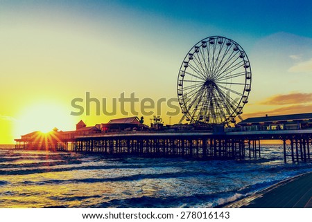 RETRO PHOTO FILTER EFFECT: Blackpool Central Pier at Sunset with Ferris Wheel, Lancashire, England UK