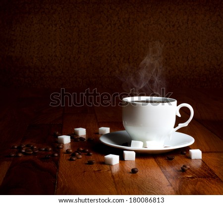Fresh cup of hot coffee with sugar and natural grains on a wooden table