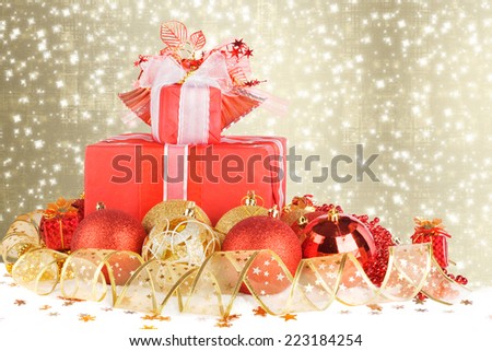 Christmas gifts and balls with gold ribbon on a beautiful abstract background