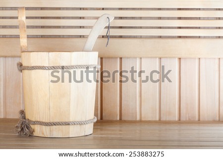 Traditional wooden sauna for relaxation with bucket of water