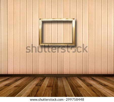 Interior of room with striped wallpaper and gold wooden frames for paintings