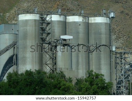 Concrete Factory with Copy Space Sign is an industrial factory with four tall silos.