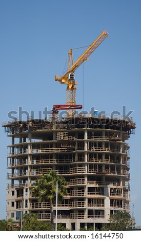 Business Building Contruction Crane is at the top of a new high rise project in St. Petersburg, Florida