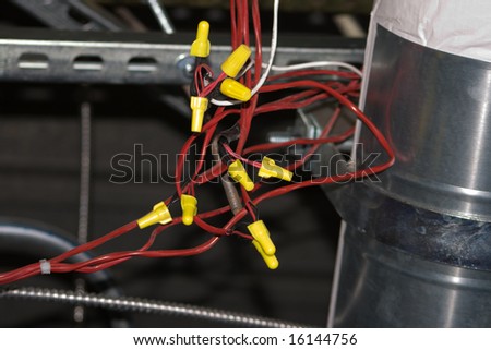 Exposed Electrical Wiring Harness with red wires and yellow connectors. Very nice contrast between the colors in the composition.