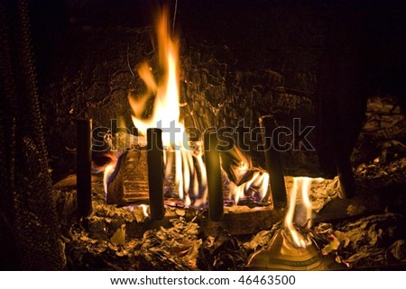 Flames of Fire Burning Flavor Nutrition Paper in a Fireplace against a black Background