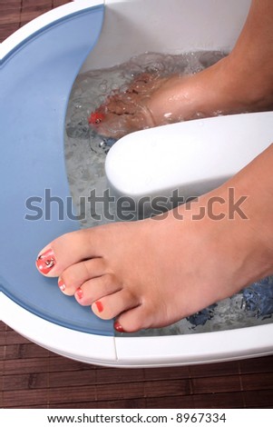 beautiful woman\'s foot relaxing in the water