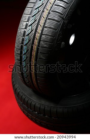 Brand new winter tire pattern on red background