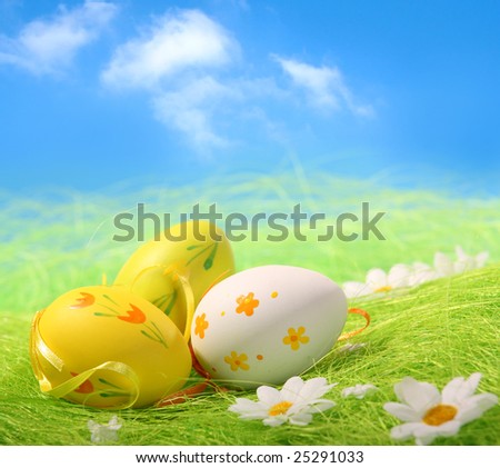 Easter Eggs sitting on grass field with blue sky background