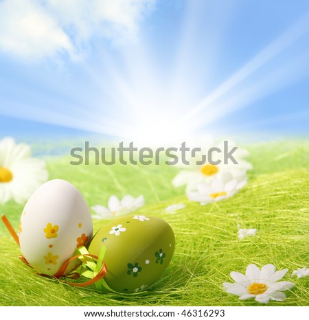Easter Eggs sitting on grass field with blue sky background