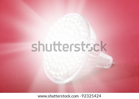 LED light bulb spot light on red background