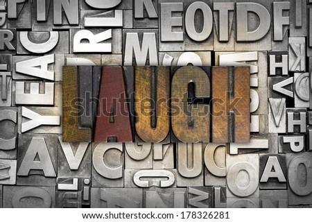 The word LAUGH written in vintage letterpress type