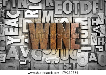 The word WINE written in vintage letterpress type