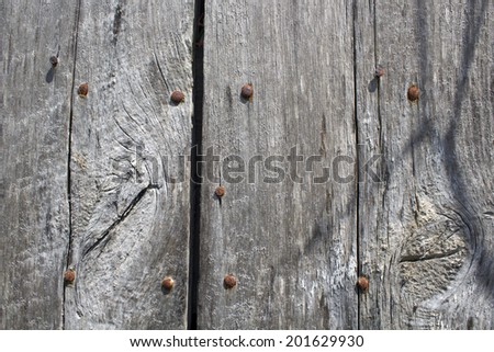 Aged wood background with rusting bolts
