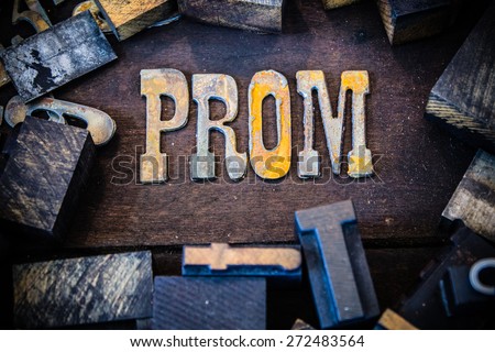 The word PROM written in rusted metal letters surrounded by vintage wooden and metal letterpress type.