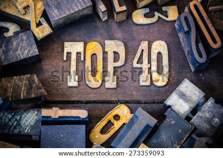 The words TOP 40 written in rusted metal letters surrounded by vintage wooden and metal letterpress type.