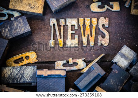 The word NEWS written in rusted metal letters surrounded by vintage wooden and metal letterpress type.