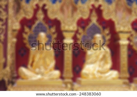 2 Buddha Statue is a beautiful golden temple builders blurred background.