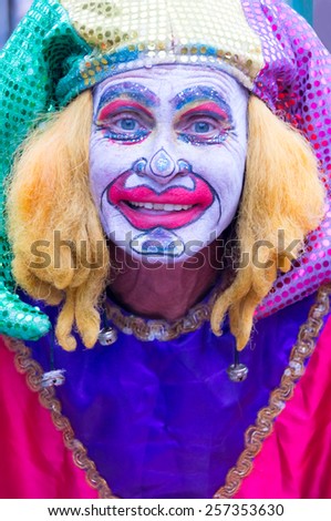 NEW ORLEANS-JUL 14: Street performer dressed as Madri Gras Clown on JUL 14, 2011. The city has up to ten million visitors annually.
