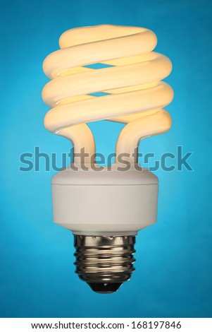 Compact fluorescent light bulb (CFL) on blue background.