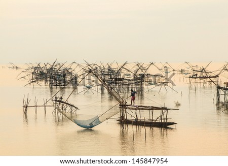 a floating basket for keeping live fish in water before sunrise from thailand
