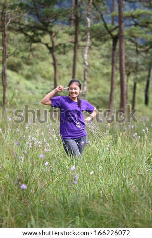 happy girl act in pine forest northeast of thailand