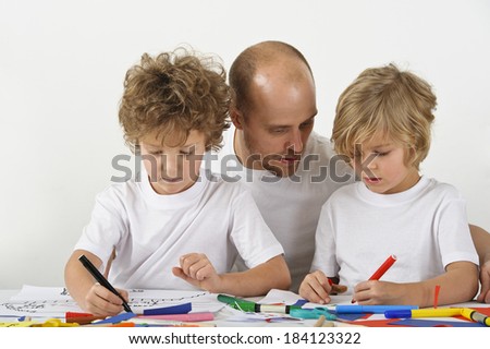 Father teaches his sons how to draw