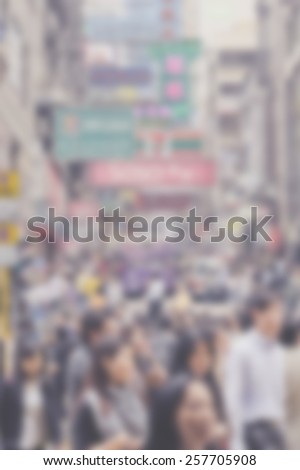 Blurred city background suitable as a background for text. Designed to work with most text colors including white. Artistic intent with filters and desaturation. Very crowded. Shop signs