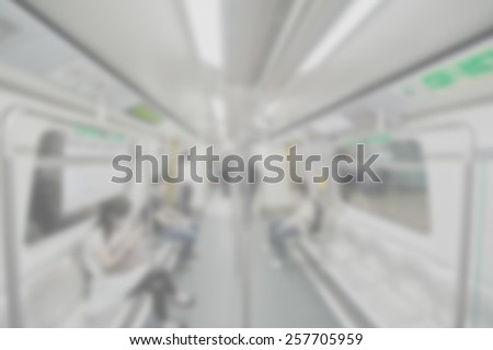 Blurred background of metro carriage interior. Suitable  as a background for most text colors including white. Artistic intent with filters and desaturation.