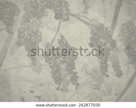 Blurred monochrome bunches of grapes on the vine. Designed to work with text overlays including the text colour white. Artistic intent with filters and desaturation.