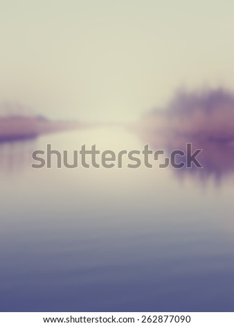 Blurred background of a river disappearing into the horizon. Designed to work with text overlays including the text colour white. Artistic intent with filters and desaturation.