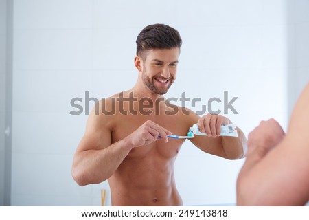 Young man brushing teeth close up shoot