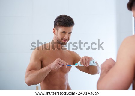 Young man brushing teeth close up shoot
