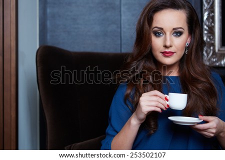 Beautiful woman drinking coffee in a apartment