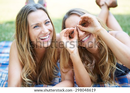 Two Female Friends Enjoying Picnic Together in Nature