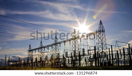 Sun setting over an electrical substation.