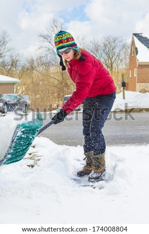 Woman Snow Shoveling Driveway