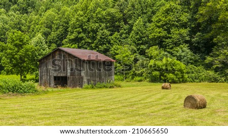 North Carolina Barn With Round Bales in Field