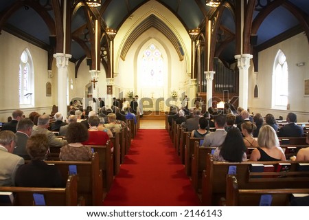 stock photo A wedding in a church looking down the aisle during the 