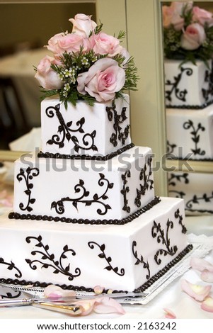 a wedding cake with pink roses. very shallow depth of field