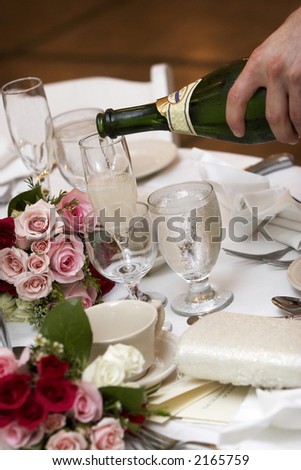 champagne being poured into fluted glasses during a wedding or social event
