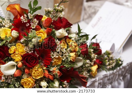  brides wedding flowers with a guestbook barely visable in the background