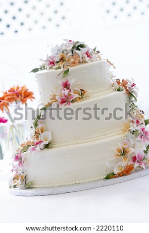 a beautiful wedding cake with a georgeous candy flower arrangement. This image is heavily back lit with a blown out background