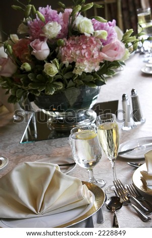 tables set for fine dining during a wedding event. Shallow depth of field, focus on items on the bottom of the table