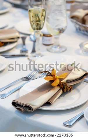 stock photo Details of a wedding table set for fine dining with an orchid