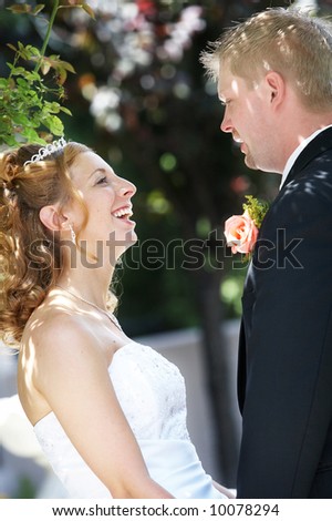bride and groom talking and laughing, focus on her face