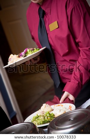 food being served by a waiter during a wedding or catered social event