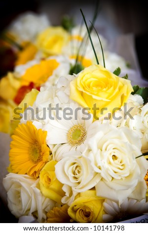 wedding bouquet of mixed flower arrangement with yellow and white